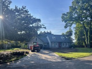 An excavator on a residential property after land clearing by Stewart Tree Service in Mount Pleasant, SC.