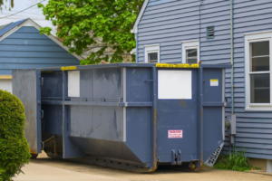 A large blue roll-off dumpster placed for residential junk removal services, typical of jobs in West Fargo, ND.