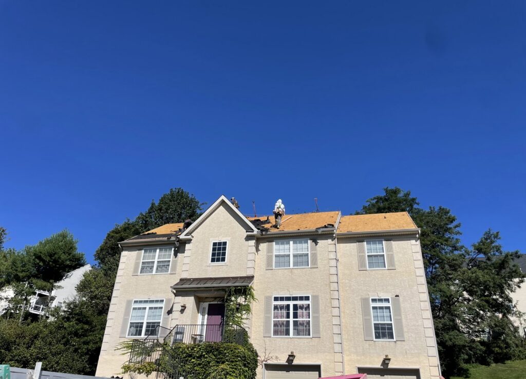 A crew of workers performing a residential roof installation, a service offered by RepairTo Roofing, Renovations & Repairs in Wilmington, DE.