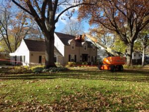 A worker in a boom lift performing roof repair on a residential house by Roof-Rite Solutions, LLC in Council Bluffs, IA