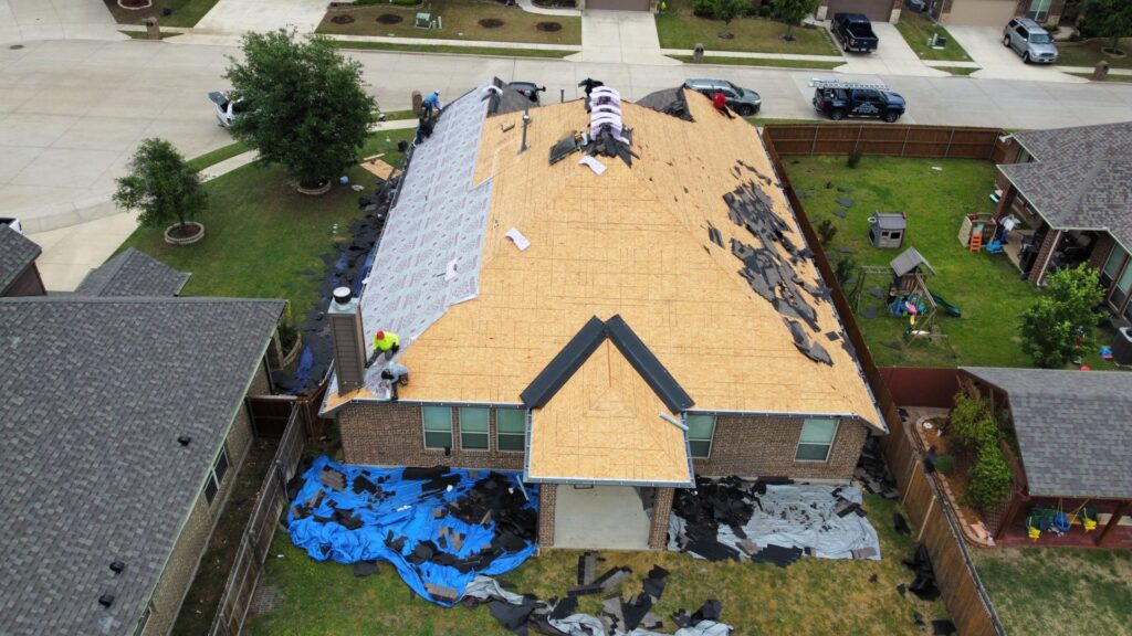 Aerial view of a residential roof repair project in progress by Canek Construction LLC in Fort Worth, TX