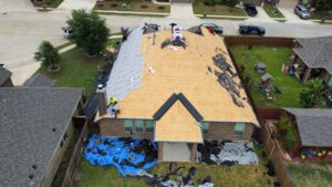 Aerial view of a residential roof repair project in progress by Canek Construction LLC in Fort Worth, TX
