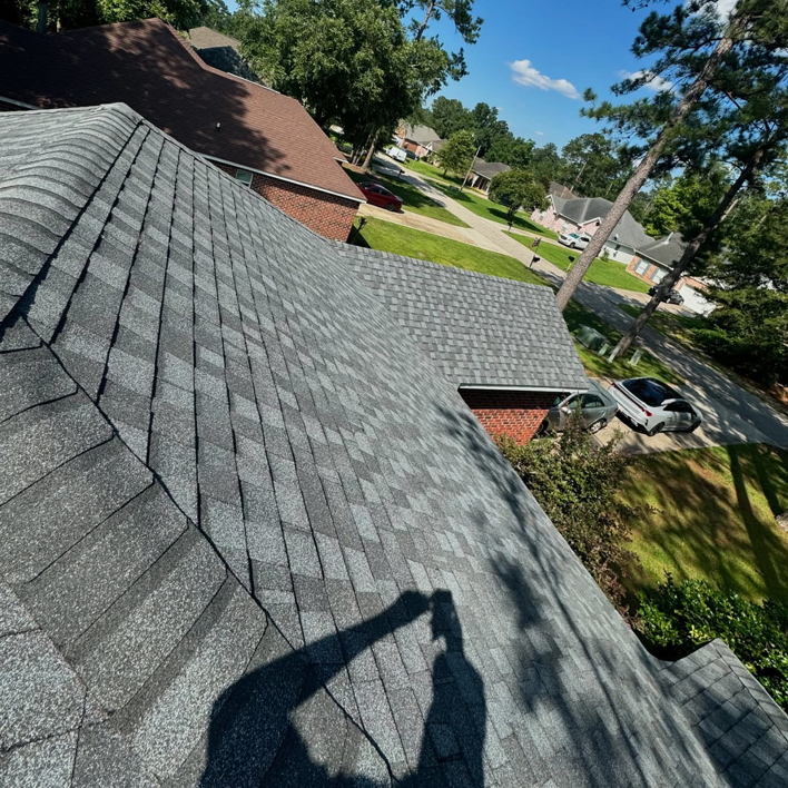 An aerial view of a newly replaced residential roof by Caliber Roofing LLC, serving homes in Meridian, ID.