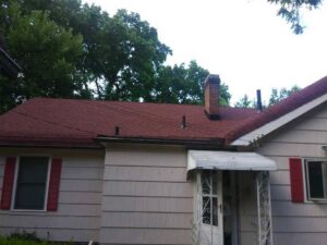 A residential home with a newly installed red shingle roof, a completed project by Elk Building Services in Toledo, OH.
