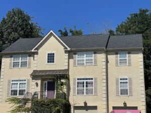 A residential house with a roof replacement in progress, showing exposed plywood decking by RepairTo Roofing, Renovations & Repairs in Wilmington, DE.