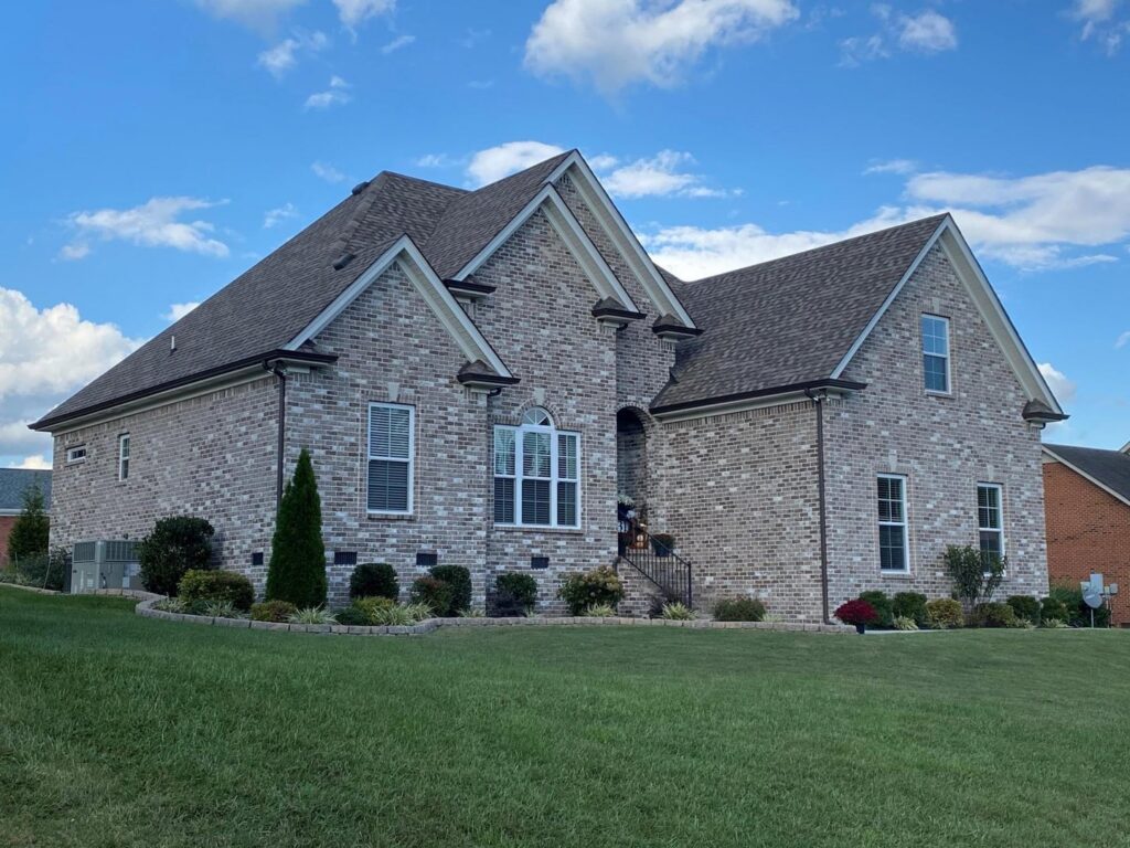 Exterior view of a residential house with a newly replaced roof by MDN Roofing 2 Flooring LLC in Fort Worth, TX.