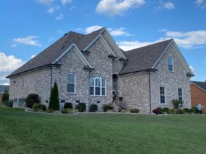 Exterior view of a residential house with a newly replaced roof by MDN Roofing 2 Flooring LLC in Fort Worth, TX.