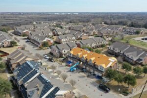 Aerial view of a residential neighborhood with multiple roof replacement projects by PaRu Construction LLC in San Antonio, TX