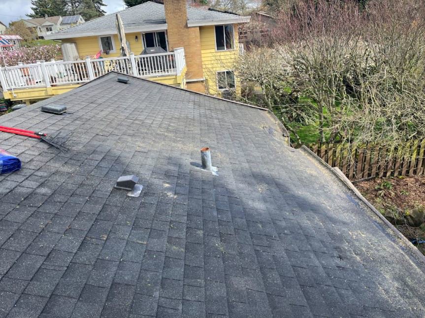 A residential roof in Seattle, WA, covered in sawdust and debris after professional tree work by Sound Tree Care LLC.