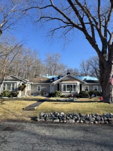 Workers installing blue underlayment on a residential roof for Joe's Roofing in Strongsville, OH.