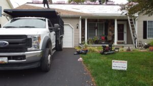 A residential roofing project in progress with workers on the roof, handled by Artstone Exteriors & Renovations in Myersville, MD.
