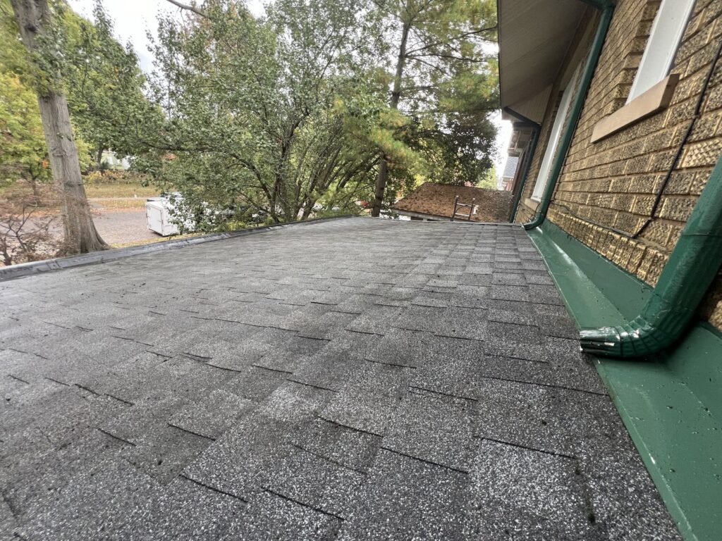 A residential shingle roof showing signs of wear, indicating a need for maintenance or cleaning by OG Renovations in Huntington, WV.