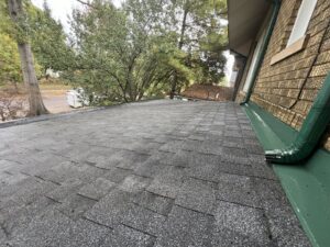A residential shingle roof showing signs of wear, indicating a need for maintenance or cleaning by OG Renovations in Huntington, WV.