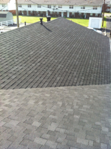 An aerial view showing two residential shingle roofs, highlighting roofing services by SJL Contracting, LLC in Owensboro, KY.