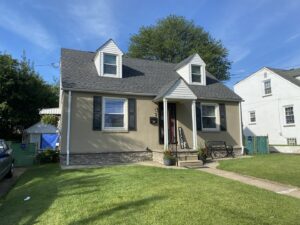 A residential house featuring a new shingle roof and dormers installed by RHI Construction Inc in Philadelphia, PA.