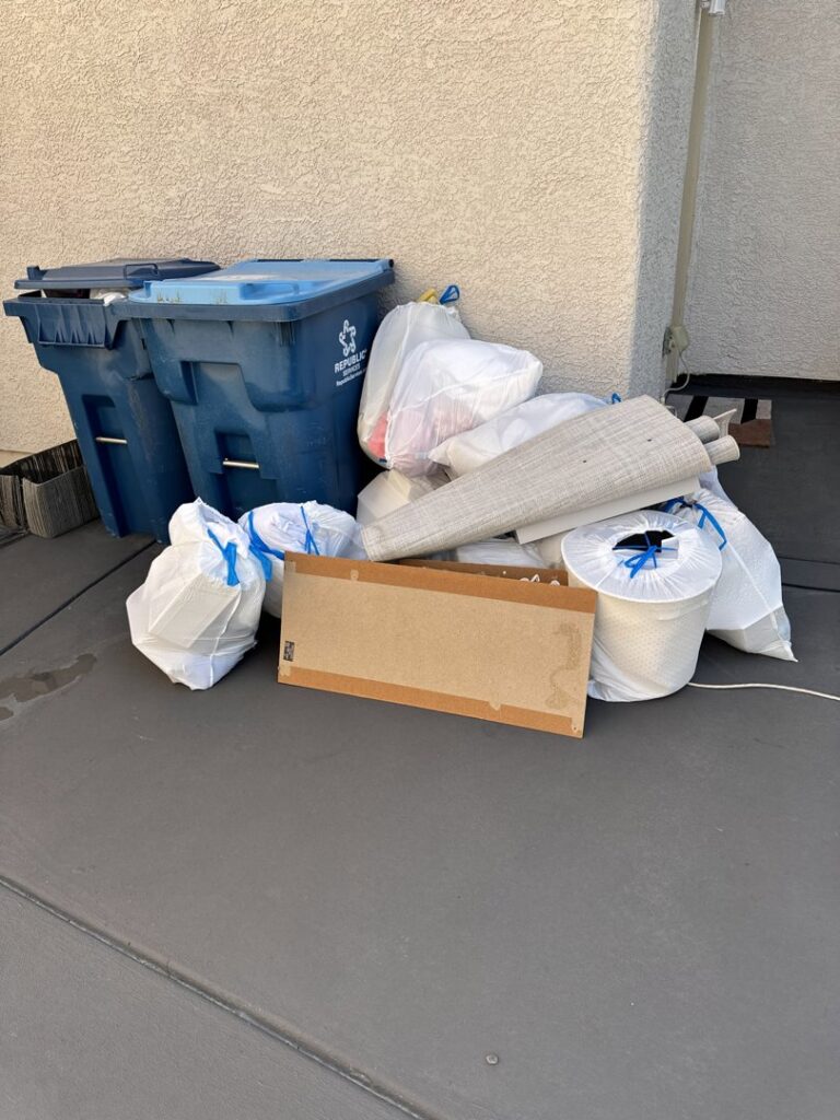A pile of residential trash bags and cardboard boxes ready for junk removal by Gone Junkin' Vegas in Henderson, NV.