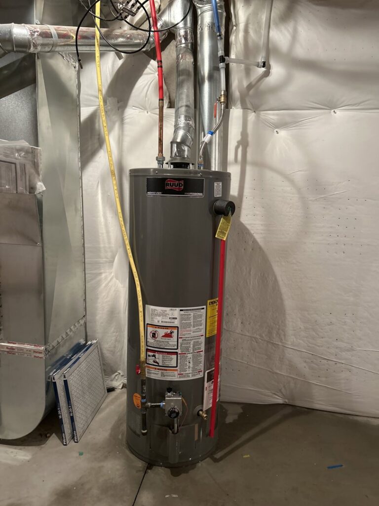 A residential water heater installed in a utility space by Top-Notch Plumbing, Heating & Air in Greeley, CO.