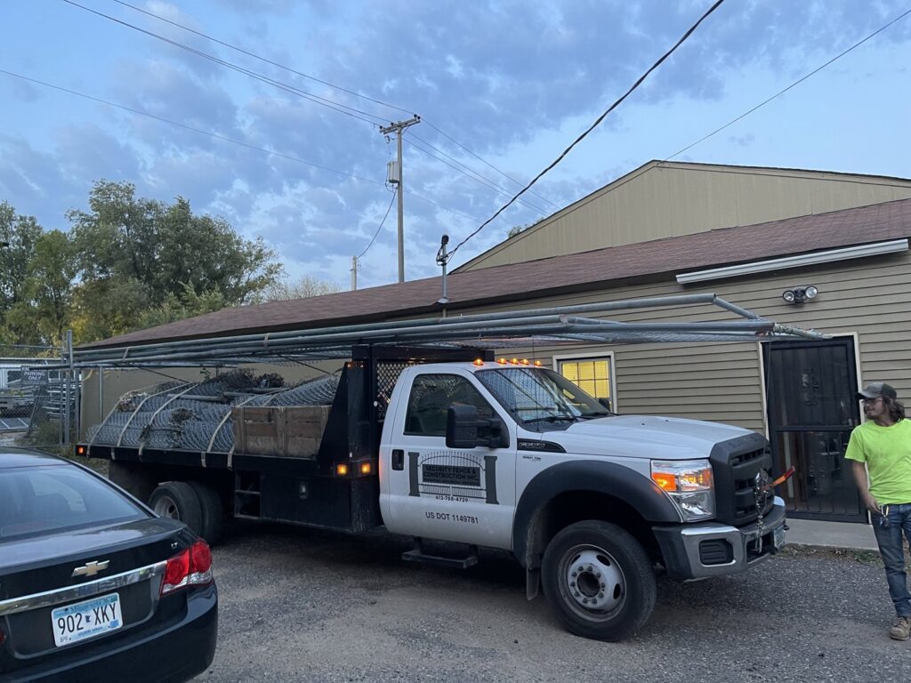 A newly installed wooden fence with a gate in a residential backyard by Security Fence & Construction Inc in Minneapolis, MN.