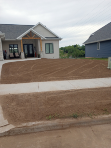 A residential front yard after grading and preparation by Todd's Mini-Tractor/Backhoe Services in Appleton, WI.