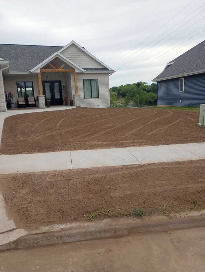 A residential front yard after grading and preparation by Todd's Mini-Tractor/Backhoe Services in Appleton, WI.