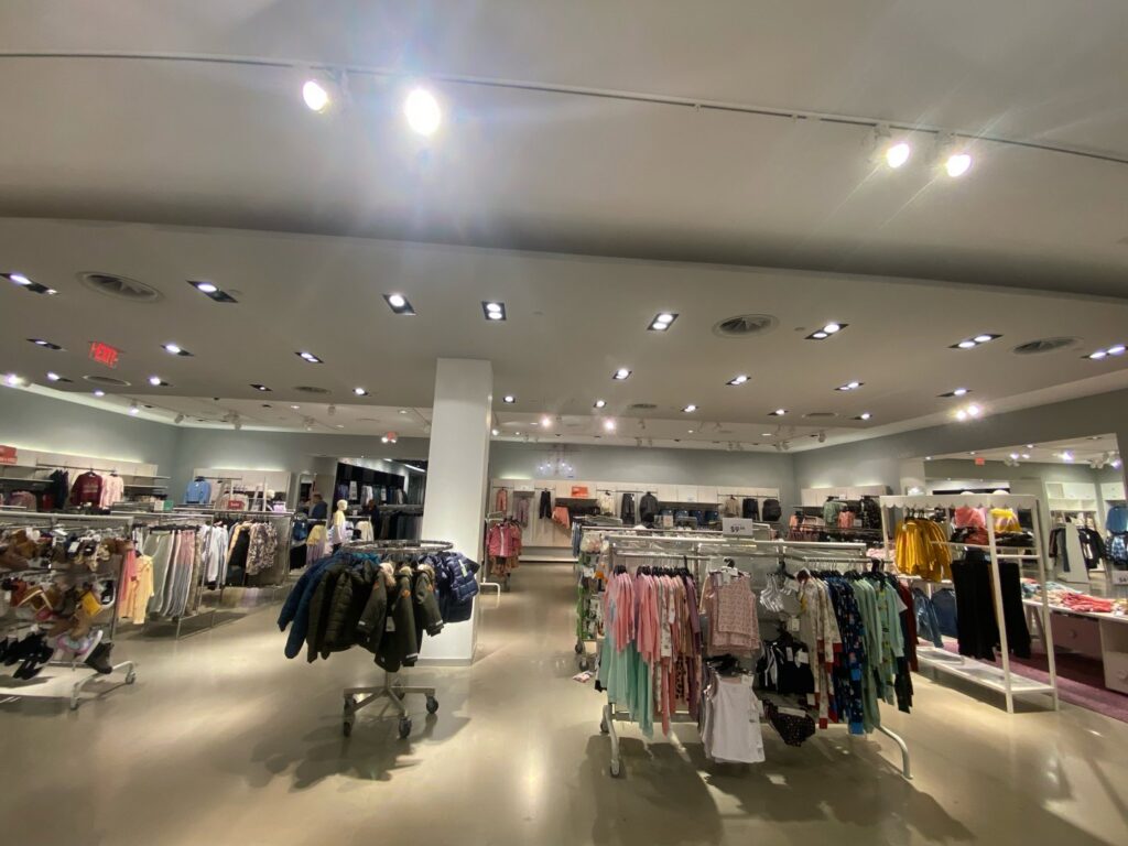 The interior of a renovated retail clothing store, demonstrating commercial fit-out services by Spectrum Paint and Commercial Services, Inc. in Houston, TX.