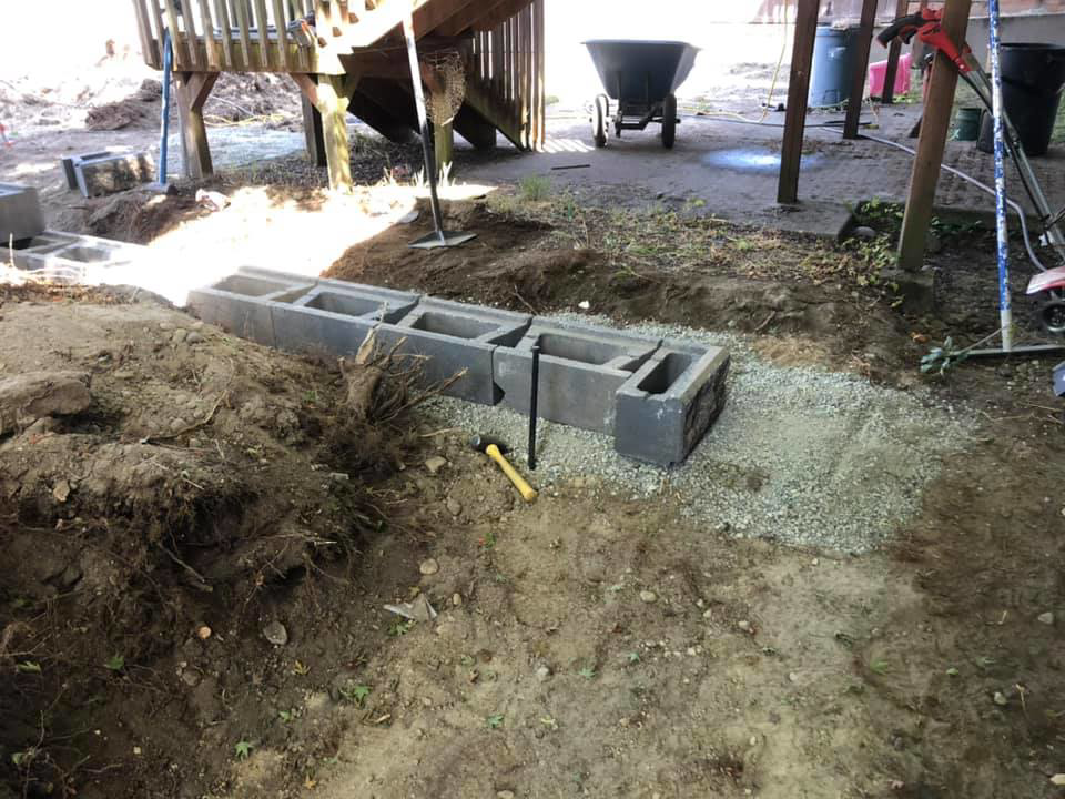 Concrete blocks being laid for a new retaining wall by M.C.Dirtworks, a handyman service in Caldwell, ID.
