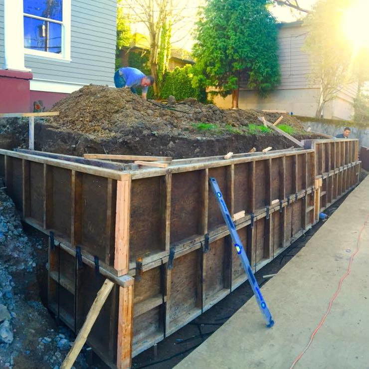 Building a wooden retaining wall formwork for a construction project by Changing Spaces Construction LLC in Portland, OR.