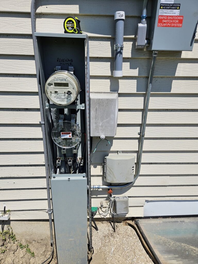 A revenue meter being installed on the side of a house by Paramount Development in Milwaukee, WI.