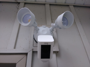A Ring Floodlight Cam security camera installed on exterior siding by Home Solutions of Kansas City in Kansas City, MO