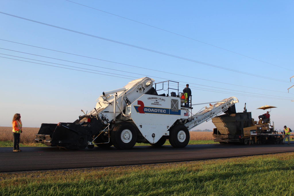 Road paving equipment and crew working on a new road for Truman L Flatt & Sons in Springfield, IL.