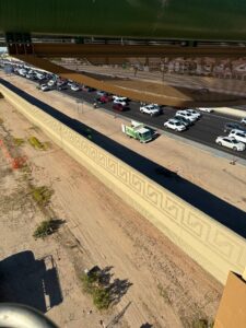 An aerial view of a roadside cleanup operation with a Skunky's Junk Removal truck on the highway in Tempe, AZ.