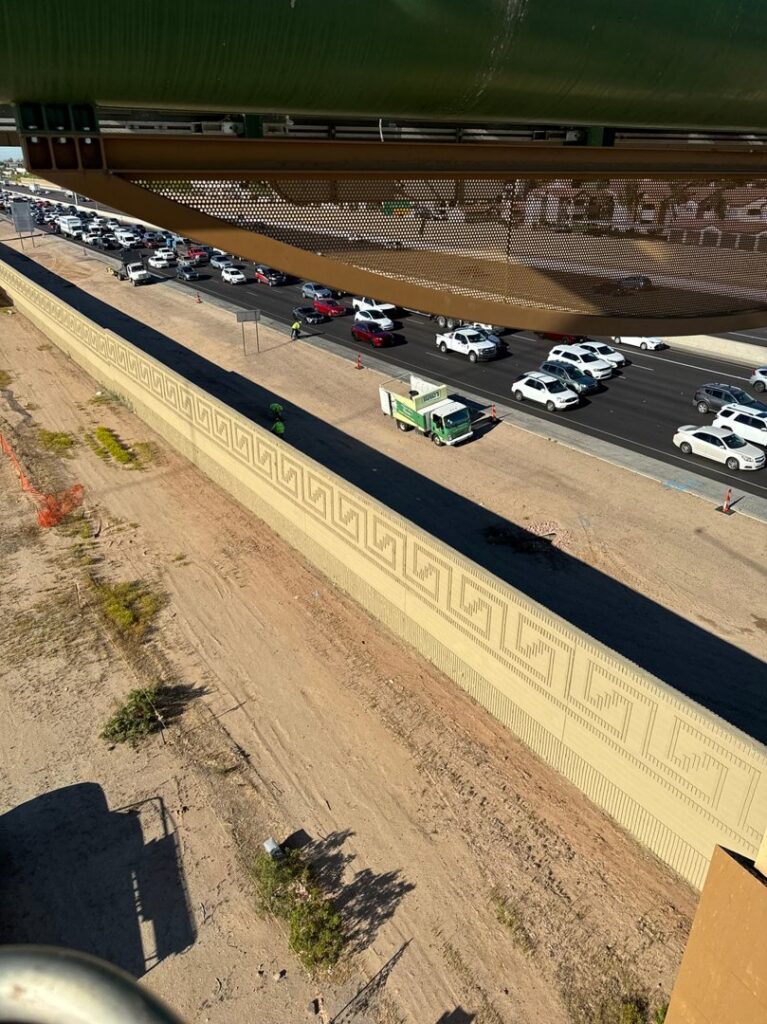 An aerial view of a roadside cleanup operation with a Skunky's Junk Removal truck on the highway in Tempe, AZ.