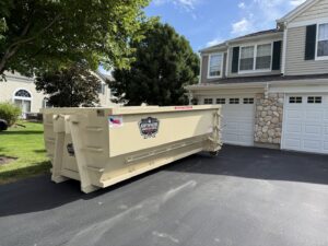 A roll-off dumpster being loaded with junk and debris, demonstrating a junk removal service by Anywhere Dumpster Rental in Naperville, IL.