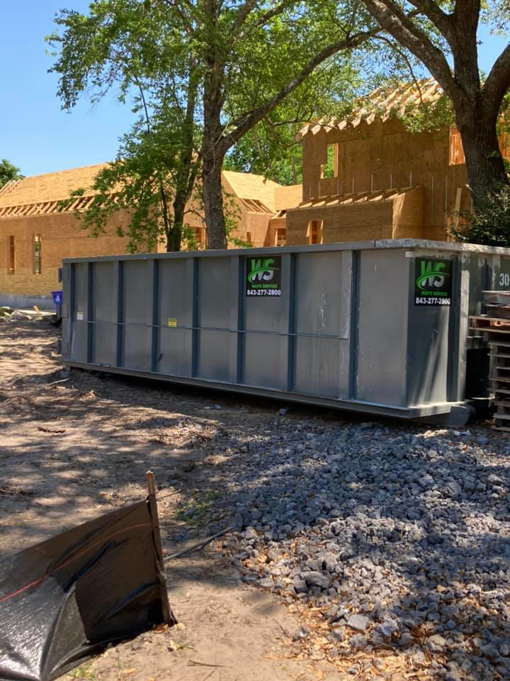 A large roll-off dumpster from Waste Services, LLC for construction debris removal in Charleston, SC.