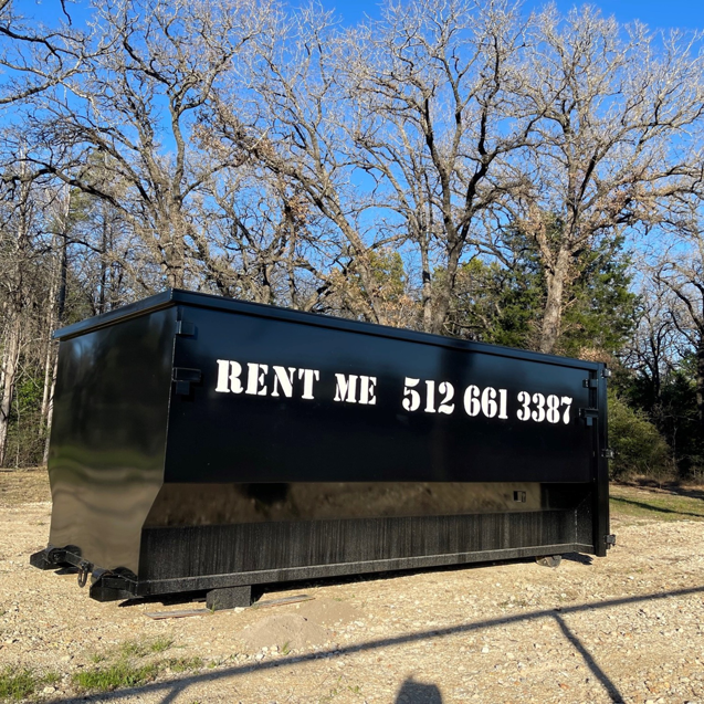 A black roll-off dumpster with 'RENT ME' text, available for rental from Team512 in Austin, TX