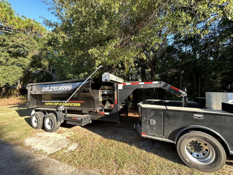 A Super Duper Dumpsters roll-off trailer ready for dumpster delivery or pickup services in Mobile, AL.