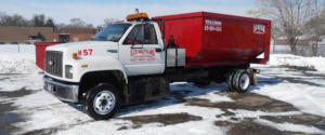 A red roll-off dumpster truck from SS ROLL OFF Dumpsters ready for junk removal service in Rockford, IL.