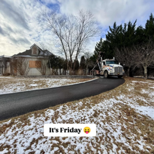 A J.Cipas Container Service roll-off truck on a snowy driveway for residential junk removal in South Plainfield, NJ.