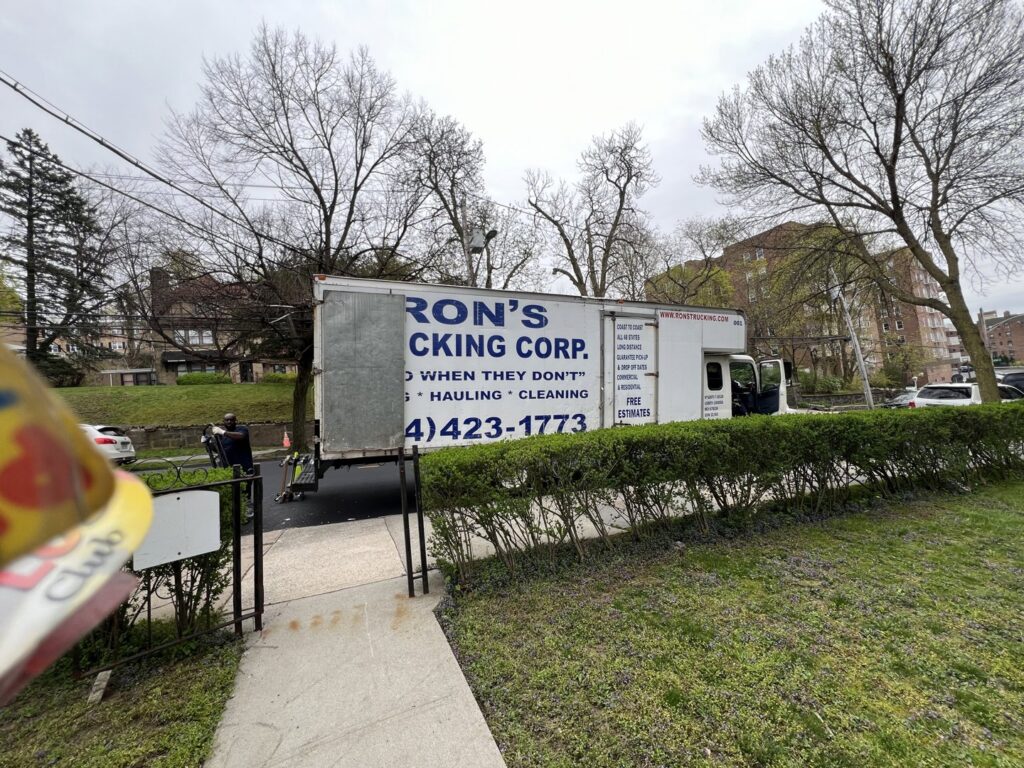 A Ron's Rubbish & Junk Removal Cleanout Services truck parked on a job site in Yonkers, NY, ready for a cleanout.