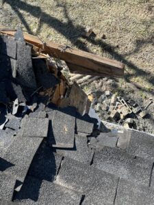 Close-up of roof damage caused by a fallen tree, indicating storm clean-up by Arbor Elite SC in Columbia, SC.