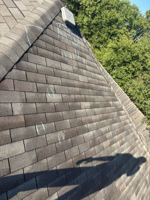 Close-up of a shingled roof with chalk marks indicating damage during an inspection by KDB Roofing & Construction in Tulsa, OK