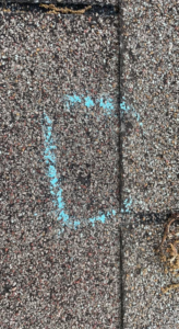A shingle roof with a blue chalk square indicating an area of damage or concern for repair by Ramirez Roofing and Repair, LLC in Kansas City, MO.