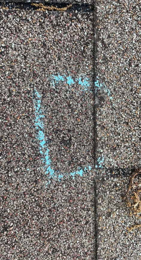 A shingle roof with a blue chalk square indicating an area of damage or concern for repair by Ramirez Roofing and Repair, LLC in Kansas City, MO.