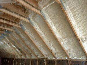 Wide view of spray foam insulation applied to a roof deck with framing by Insulation By Cohen's in Moncks Corner, SC.
