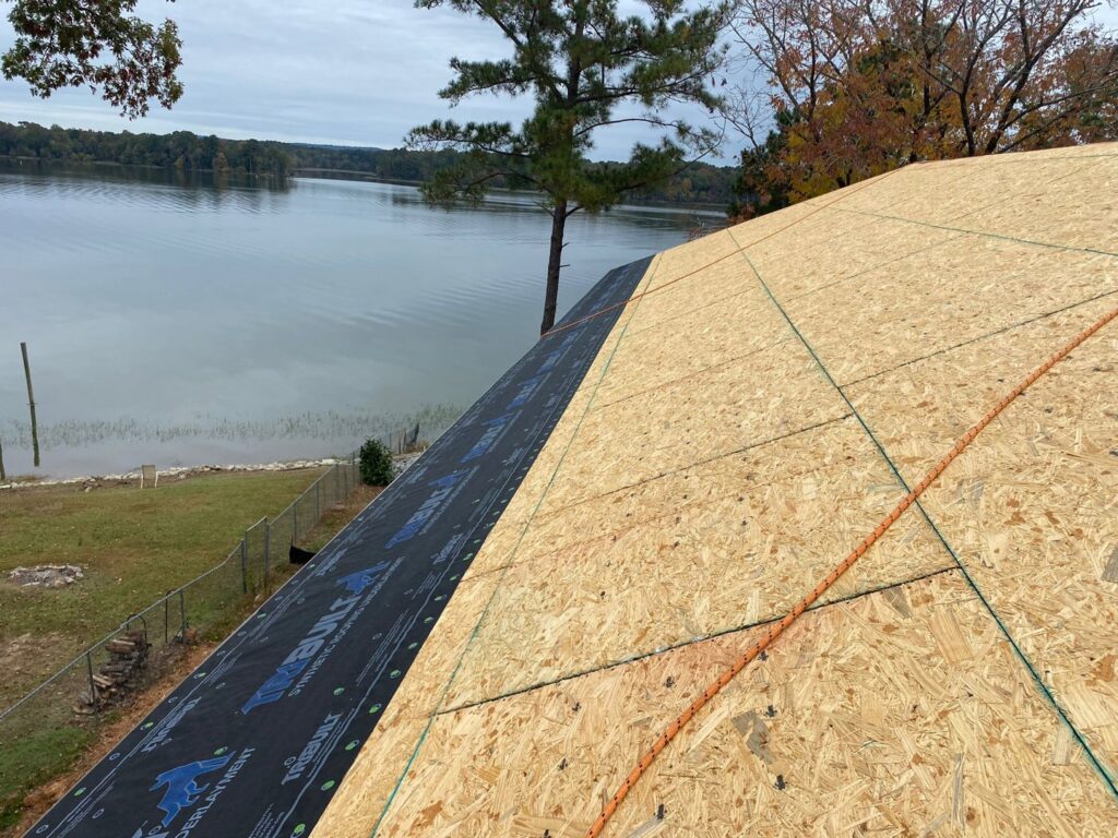 Plywood roof decking and underlayment installed on a lakeside home, a project by Roofing Experts Care in Charlotte, NC.