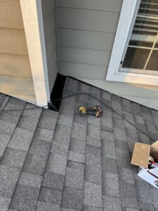 A close-up of roof detail work with a drill on a shingled roof by Sunny's roofing LLC in Denver, CO.