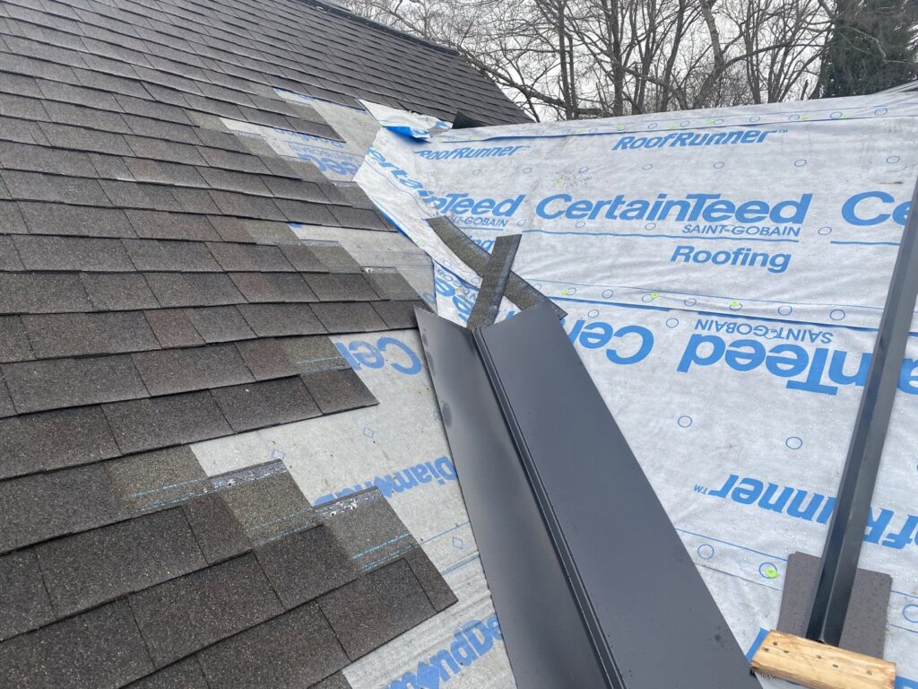 Metal flashing and new shingles being installed on a roof by Sunny's roofing LLC in Denver, CO.