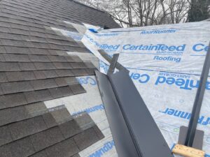 Metal flashing and new shingles being installed on a roof by Sunny's roofing LLC in Denver, CO.