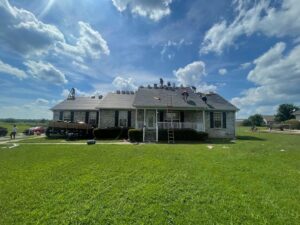 Two workers on a residential roof, possibly performing an inspection or repair for Southern Roofing and Renovations Clarksville in Orlando, FL.