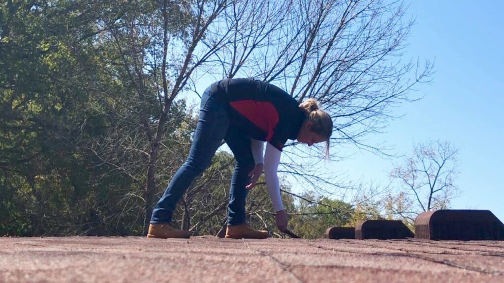 A professional conducting a thorough roof inspection service by Gwen Co in St. Louis, MO.